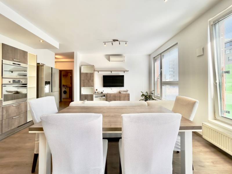 Living room connected with the kitchen, wooden decor flooring, spacious 3-room apartment.