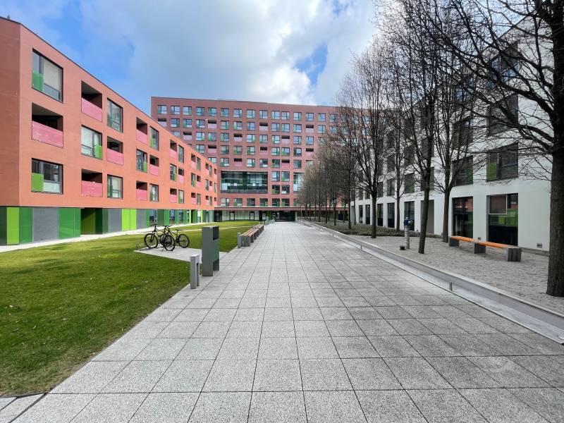 New buildings with colorful facades on Košická Street in Bratislava - Nivy, surrounded by greenery.