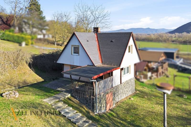 A cottage on Kováčov Street in Štúrovo with a grassy plot and a view of the surrounding countryside.