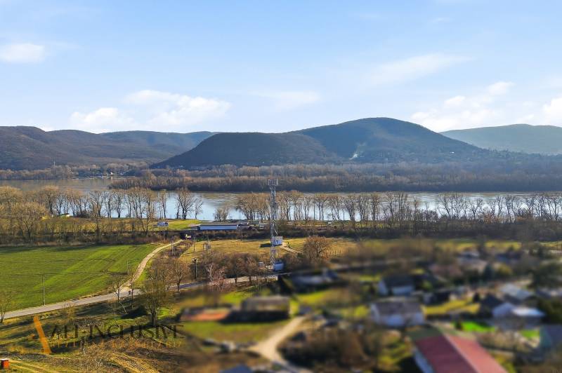 A view of the landscape with hills, a river, and a village near Štúrovo on Kováčov Street.