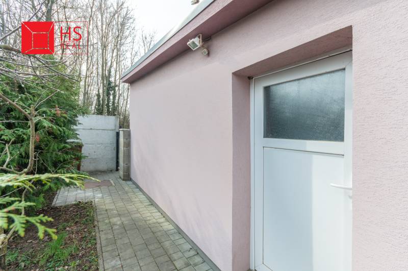 A family house in Šurany with a pink facade and white doors.