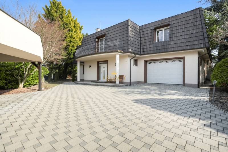 A family house in Ivanka pri Dunaji with a pitched roof and a garage on a paved yard.