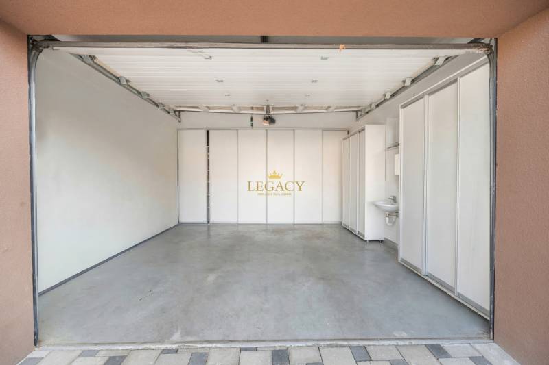 A garage with white walls and a concrete floor in a family house in Ivanka pri Dunaji.