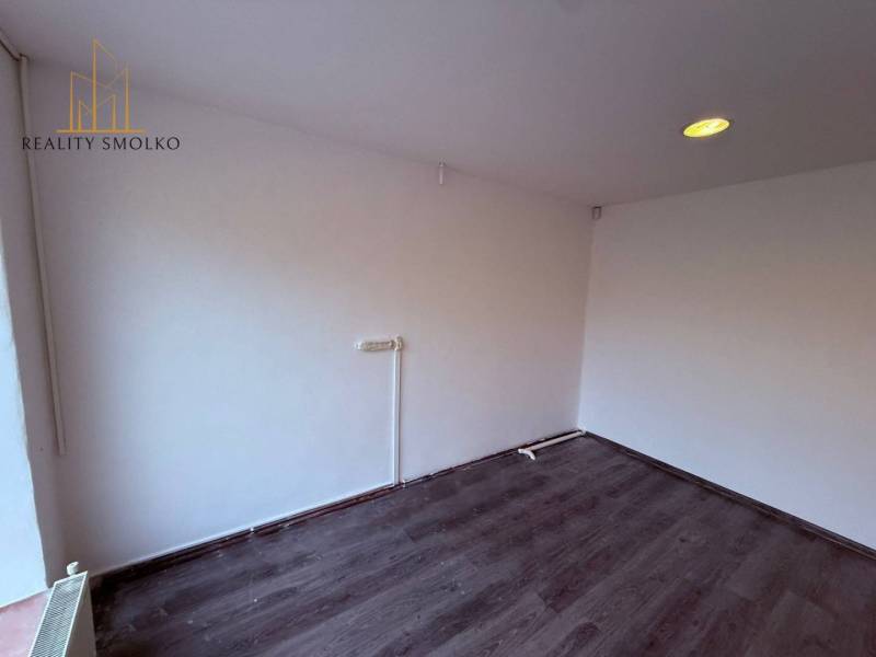 Commercial spaces with white walls and wood-patterned flooring.