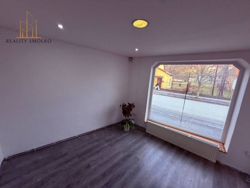 Commercial spaces with large windows and a floor with a wooden decor.