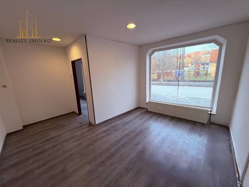 Commercial spaces with a large window and a wooden decor floor.