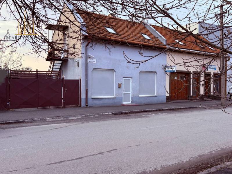 A building with commercial premises on Čapajevova Street in Prešov, with a renovated facade and roof.