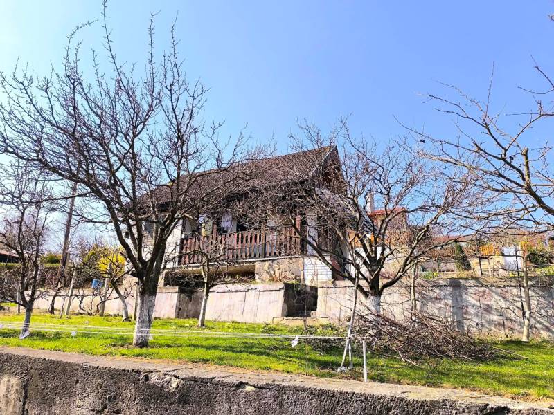 A cottage in Malé Krštenany with a garden and fruit trees during clear weather.