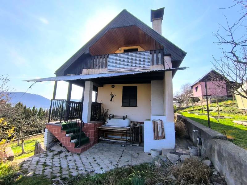 A cottage in Malé Kršteňany with a terrace, garden, and a view of the countryside.