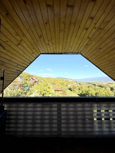 The view from the cottage of the surrounding green hills and houses in Partizánske.