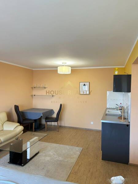 Living room with a kitchenette in a 3-room apartment, floor with wood decor.