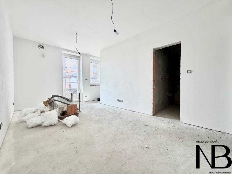 The interior of a spacious, bright studio apartment in the process of renovation.