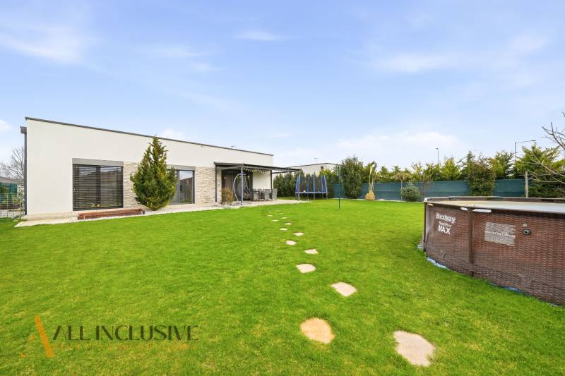 A family house in Dunajská Streda with a covered terrace, a swimming pool, and a landscaped garden.