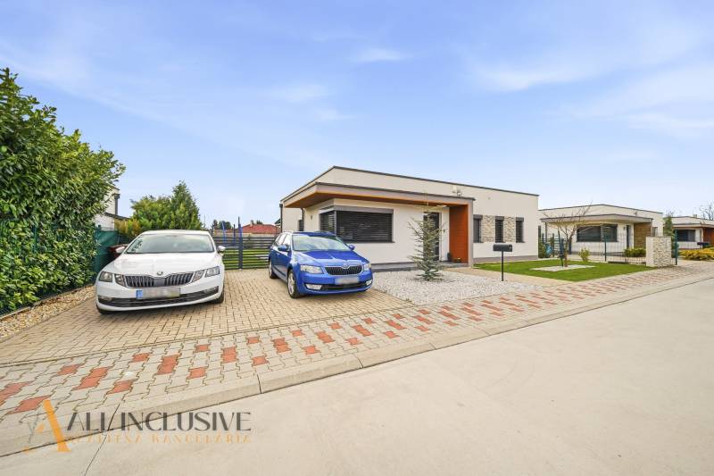 A family house in Dunajská Streda with parking spaces and a fenced garden.