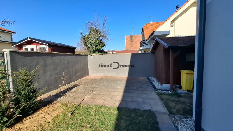 A courtyard with paving and lawn in a 3-room apartment on Nitrianska Street in Nitra.