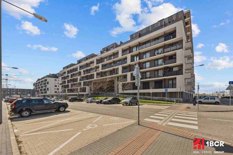 Zuzana Chalupová Street in Bratislava - Petržalka with housing estate architecture and a parking lot.