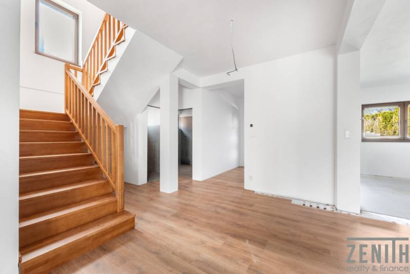 Interior of a family house with stairs and a wooden decor floor.