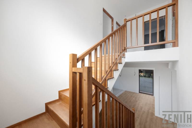 Interior of a family house with a staircase and a wooden decor floor.
