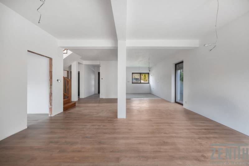 Interior of a family house with an open space and a wooden decor floor.