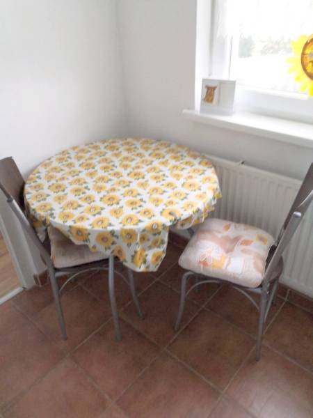 Dining nook with a table and two chairs in a studio apartment.
