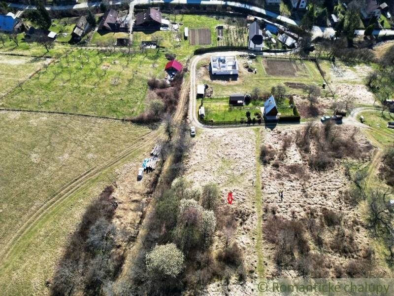 Land - housing in Vydrná with a view of family houses and greenery.