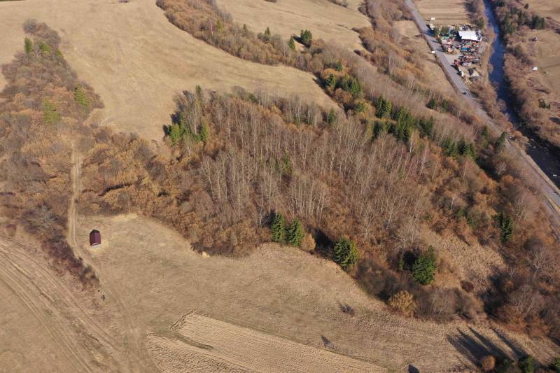 Agricultural and forest lands near Námestovo, mixed growths, and a river in the distance.