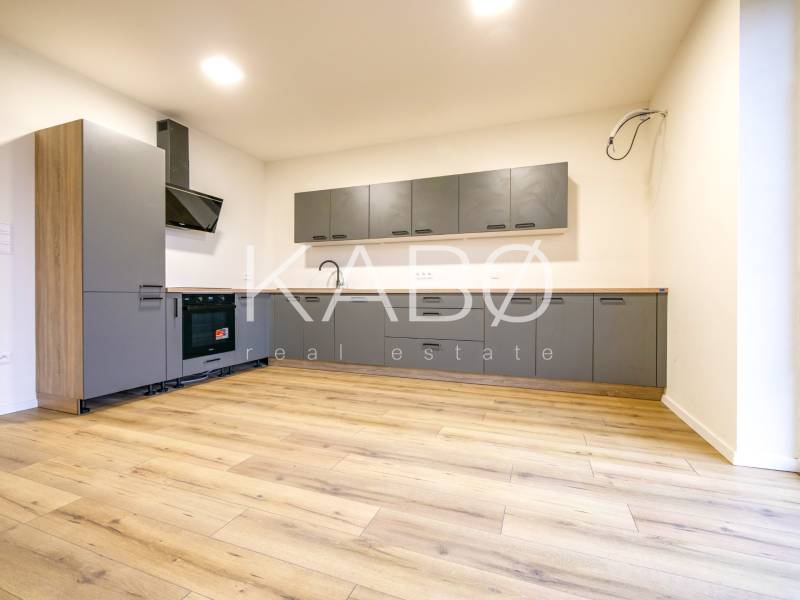 A kitchen unit in a family house with a wooden decor floor.
