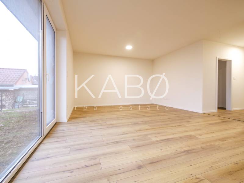 Interior of a family house with a wooden decor floor and a large window.