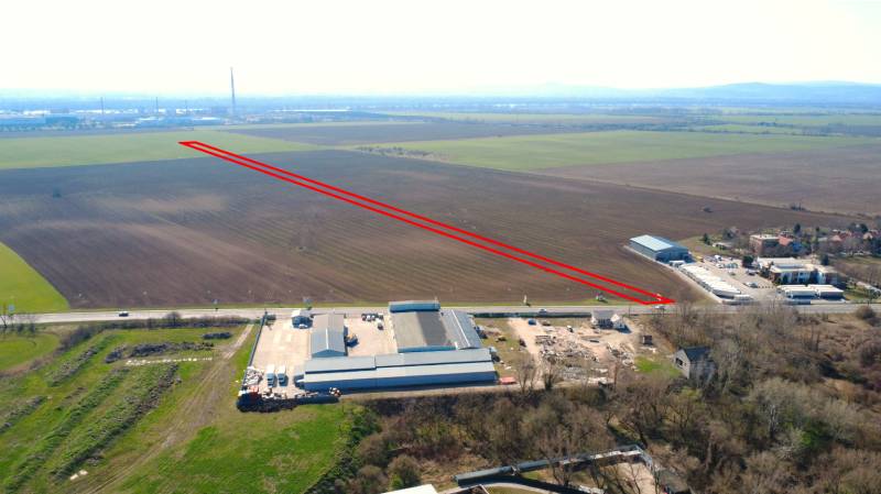 Agricultural and forest lands near Štúrovo, with an industrial building and fertile fields on the horizon.