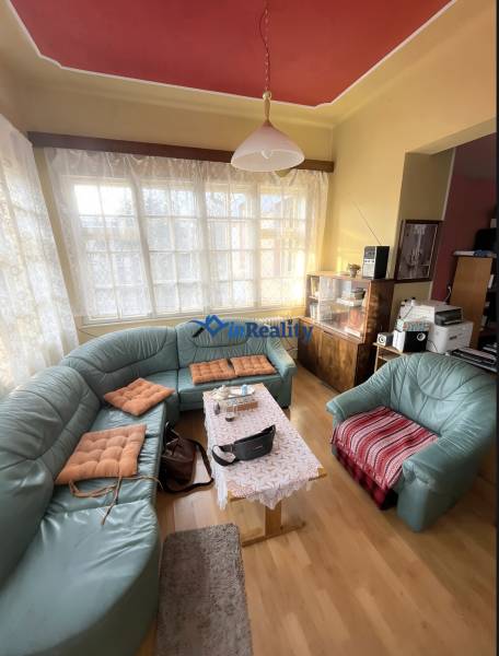 Living room in a family house with a curved sofa and a wooden decor floor.