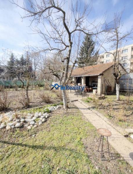 The garden of a family house on Gorkého Street in Rimavská Sobota with a wooden gazebo.