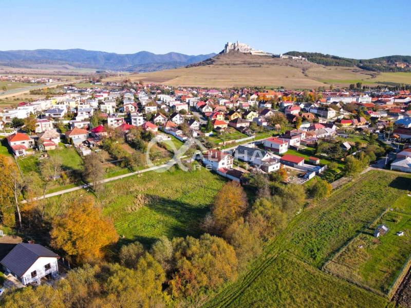 Aerial view of residential plots in Spišské Podhradie with a panorama of the castle.