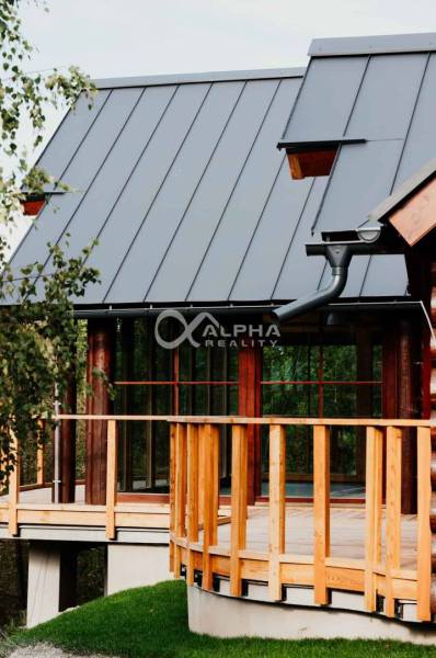 Exterior of a family house in Hnilčík with a metal roof and wooden elements.