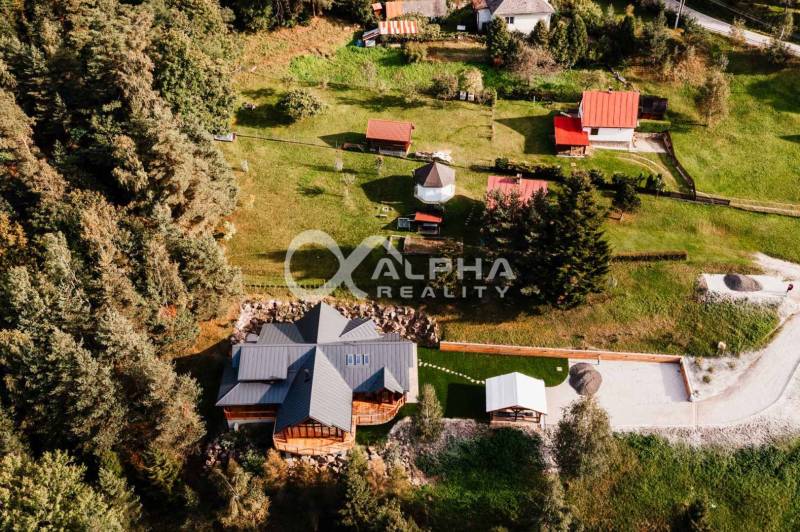 A family house in Hnilčík surrounded by greenery and forest, in a peaceful rural environment.