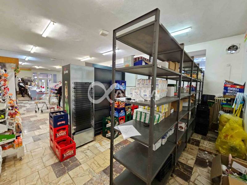A store with shelves and goods, a floor with a wooden decor, interior of a building.