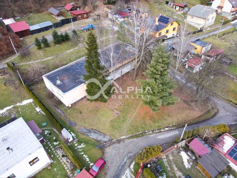 Aerial view of a building in Helcmanovce surrounded by trees and gardens.