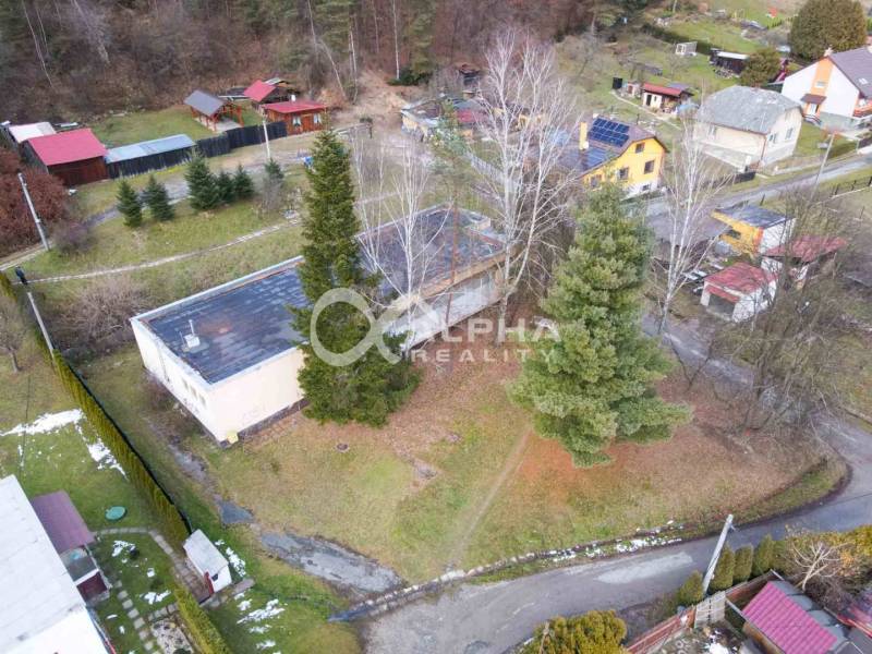 A view from above of a building in Helcmanovce surrounded by trees and gardens.
