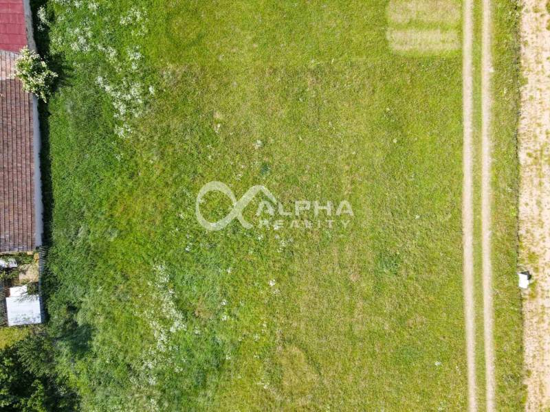 Aerial view of residential grass plots in Betlanovce, with an adjacent domestic plot.