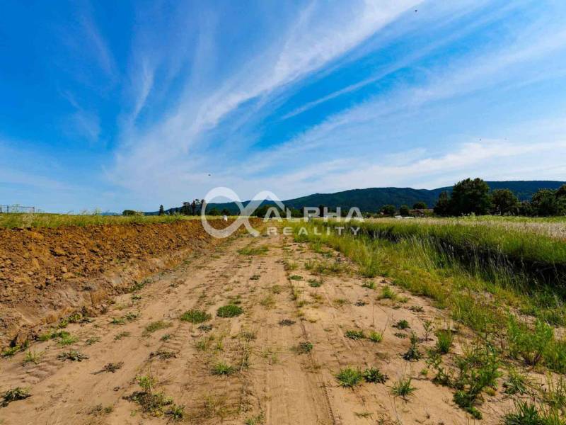 Arable land in Betlanovce for residential plots, surrounded by nature and blue skies.
