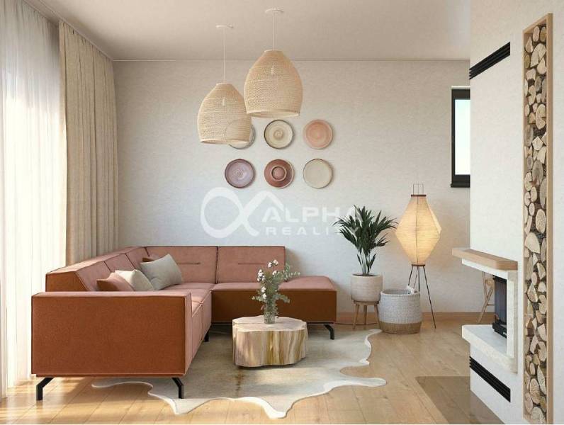 Living room with a sofa, decorative bowls, a fireplace, and a wooden-patterned floor.