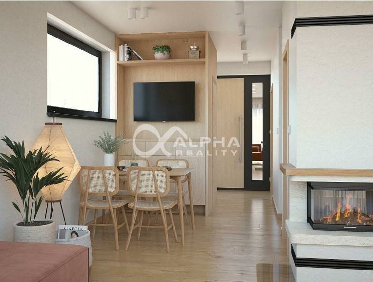 Interior design with wood-patterned flooring, a fireplace, and a dining table.