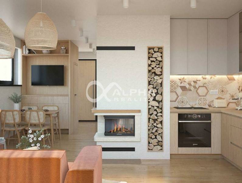 Interior space with wood-patterned flooring, a fireplace, and a kitchen with modern elements.