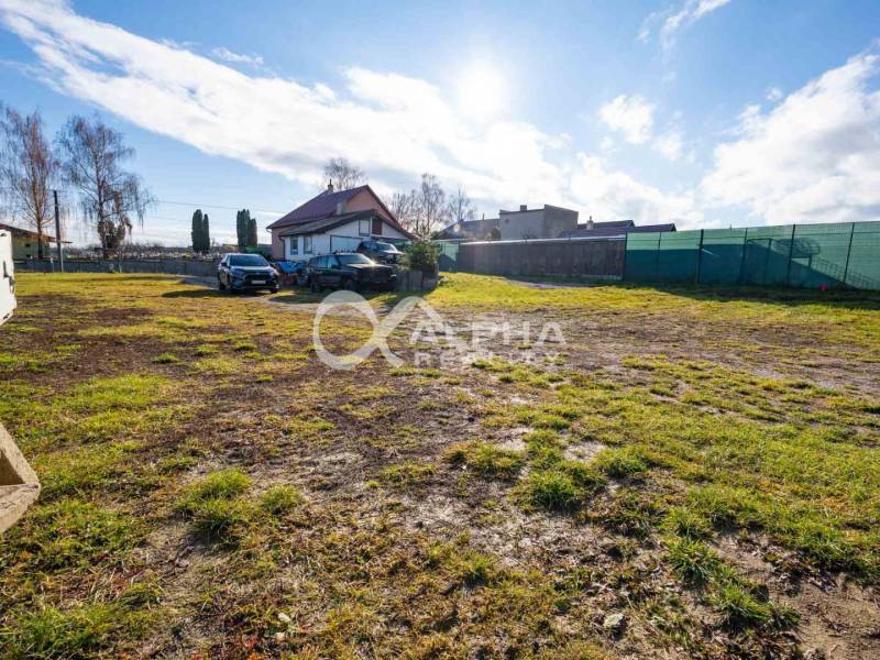 Plots - housing in Spišské Tomášovce with a grassy area and a house in the background.