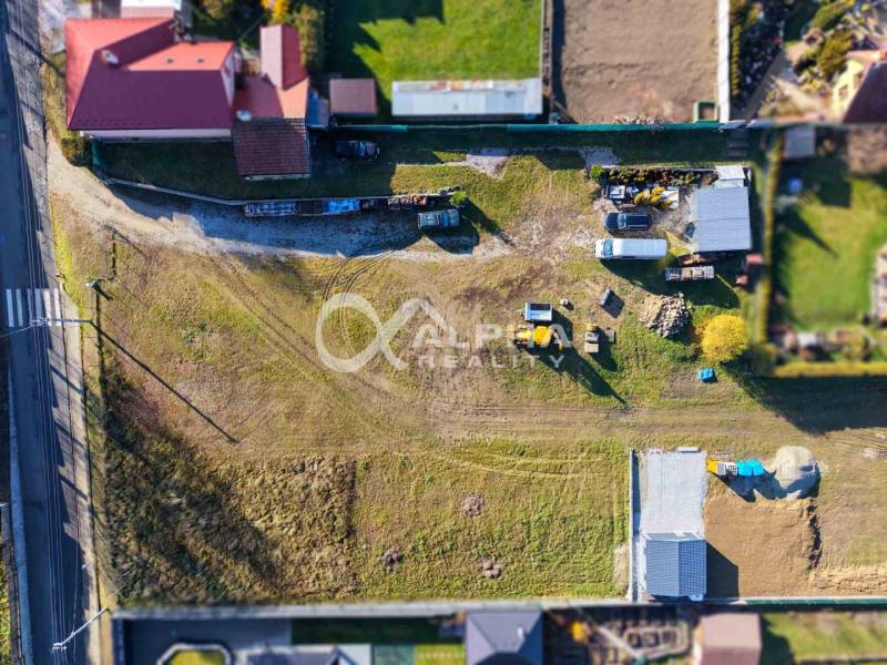Aerial view of properties - housing in Spišské Tomášovce with buildings and a road.