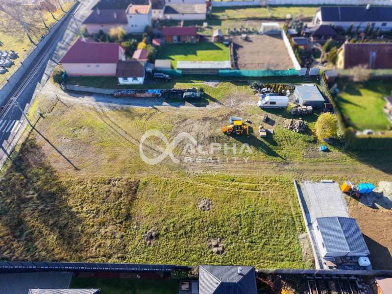 Aerial view of residential plots in Spišské Tomášovce, with visible machinery.