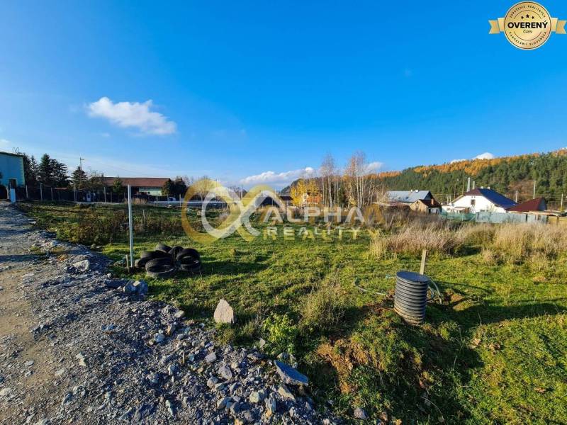 A plot for residential use in Markušovce, surrounded by nature, with visible houses in the background.