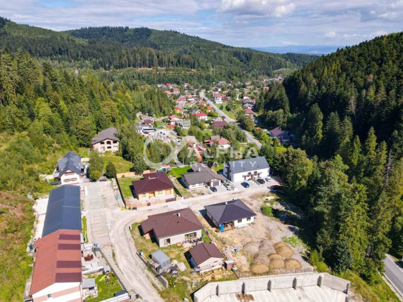 An aerial view of a picturesque neighborhood surrounded by forests in Spišská Nová Ves.