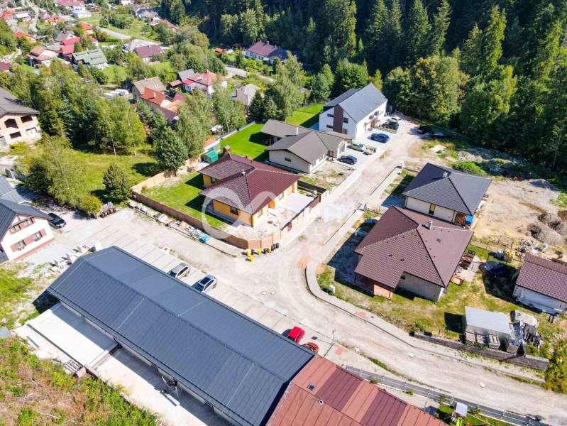 Aerial view of new houses in Spišská Nová Ves surrounded by greenery and streets.