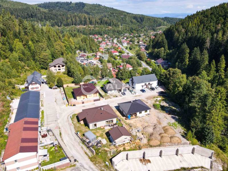 A summer view of a picturesque district in Spišská Nová Ves surrounded by wooded hills.