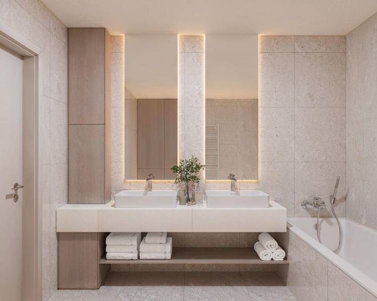 A bathroom with two sinks, a bathtub, and decorative lighting in a 3-room apartment.